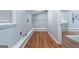 Bright laundry room with wood floor and shelving at 1694 Pheasant Dr, Atlanta, GA 30238