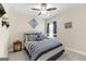 Comfortable bedroom featuring a bed with blue and white bedding, a side table, and window with blue curtains at 3735 Westhaven Dr, Cumming, GA 30040