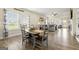 Cozy dining area adjacent to the living room, filled with natural light from large windows and comfortable seating at 3735 Westhaven Dr, Cumming, GA 30040