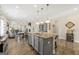 Open kitchen with a large center island and views into the living and dining areas at 3735 Westhaven Dr, Cumming, GA 30040