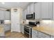 Kitchen featuring gray cabinetry, stainless steel appliances and tan granite countertops at 3735 Westhaven Dr, Cumming, GA 30040