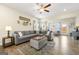 Comfortable living room featuring a large sectional sofa, a ceiling fan, and lots of natural light at 3735 Westhaven Dr, Cumming, GA 30040