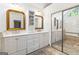 Charming primary bathroom with dual sinks, custom cabinetry, and decorative mirrors at 4729 Woodland Brook Se Ct, Atlanta, GA 30339
