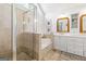 This primary bathroom features a tub, a seamless glass shower, and custom cabinetry at 4729 Woodland Brook Se Ct, Atlanta, GA 30339