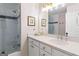 Bright bathroom featuring tiled shower with glass door and white vanity at 4729 Woodland Brook Se Ct, Atlanta, GA 30339