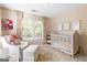 A charming Bedroom with floral wallpaper, white furniture, and a bright, airy feel at 4729 Woodland Brook Se Ct, Atlanta, GA 30339