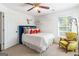 Cozy bedroom with designer decor, a ceiling fan, and a large window at 4729 Woodland Brook Se Ct, Atlanta, GA 30339