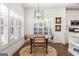 Dining area with wood floors, round table, and plantation shutters at 4729 Woodland Brook Se Ct, Atlanta, GA 30339