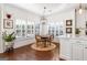 Dining area with modern chandelier, plantation shutters, and view to kitchen at 4729 Woodland Brook Se Ct, Atlanta, GA 30339