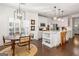 Open floorplan dining area with modern chandelier, white cabinets, and view to kitchen island at 4729 Woodland Brook Se Ct, Atlanta, GA 30339