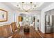 Bright dining room featuring a wooden table, wicker chairs, and a modern chandelier at 4729 Woodland Brook Se Ct, Atlanta, GA 30339