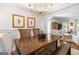 Elegant dining space with a wooden table, bench seating, and an open layout connecting to the living room at 4729 Woodland Brook Se Ct, Atlanta, GA 30339