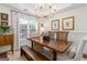 Charming dining room with a wooden table, a bench, classic decor, and bright natural lighting at 4729 Woodland Brook Se Ct, Atlanta, GA 30339