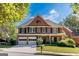 Charming two-story brick home features a manicured front lawn, two-car garage, and classic architectural details at 4729 Woodland Brook Se Ct, Atlanta, GA 30339