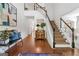 Welcoming foyer with hardwood floors, staircase, bench seating, and stylish decor at 4729 Woodland Brook Se Ct, Atlanta, GA 30339