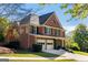 Traditional two-story brick home with a two-car garage and manicured landscaping at 4729 Woodland Brook Se Ct, Atlanta, GA 30339