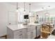 Open floor plan kitchen with white cabinets, stainless steel appliances, and island at 4729 Woodland Brook Se Ct, Atlanta, GA 30339