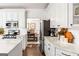 Modern kitchen with white cabinets, marble countertops, stainless steel appliances at 4729 Woodland Brook Se Ct, Atlanta, GA 30339