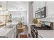 Updated kitchen with stainless steel appliances, marble countertops, and eat-in dining area at 4729 Woodland Brook Se Ct, Atlanta, GA 30339