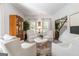 Elegant living room with white armchairs, neutral decor, and a view of the staircase at 4729 Woodland Brook Se Ct, Atlanta, GA 30339