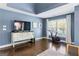 This main bedroom includes a custom dresser, home exercise bike, and windows at 4729 Woodland Brook Se Ct, Atlanta, GA 30339