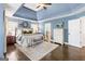 Comfortable main bedroom suite with a decorative trey ceiling, bedside tables, and ensuite bathroom at 4729 Woodland Brook Se Ct, Atlanta, GA 30339