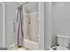 Bathroom showcasing the shower-tub combo with white tile surround, neutral grey paint and standard toilet at 830 Bonnie Glen Se Dr, Marietta, GA 30067