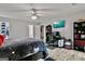 Spacious bedroom with a ceiling fan, desk area, and ample closet space for storage at 830 Bonnie Glen Se Dr, Marietta, GA 30067