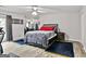 Serene bedroom with a comfortable bed, mirrored wall, ceiling fan, and natural light at 830 Bonnie Glen Se Dr, Marietta, GA 30067