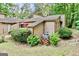 Exterior side view of the building showing the landscape with some plants around an A/C unit at 830 Bonnie Glen Se Dr, Marietta, GA 30067