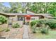 Home exterior featuring a patio with chairs, a garden, and a stone pathway leading to the front door at 830 Bonnie Glen Se Dr, Marietta, GA 30067