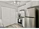 Well-appointed kitchen with white cabinets, modern appliances, and updated flooring at 830 Bonnie Glen Se Dr, Marietta, GA 30067