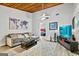 Inviting living room featuring a sectional sofa, ceiling fan, mounted tv, and a view into the bedroom at 830 Bonnie Glen Se Dr, Marietta, GA 30067