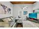 Comfortable living room featuring a stylish gray sofa, modern ceiling fan, and a large wall-mounted television at 830 Bonnie Glen Se Dr, Marietta, GA 30067