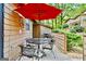 Cozy outdoor patio with a table, chairs, and an umbrella, perfect for outdoor dining and relaxation at 830 Bonnie Glen Se Dr, Marietta, GA 30067