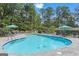 Beautiful community pool with clear water, surrounded by lush greenery and lounge chairs for relaxing by the water at 830 Bonnie Glen Se Dr, Marietta, GA 30067