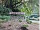 Bonnie Glen community signage with stacked stone base, surrounded by lush greenery and mature trees at 830 Bonnie Glen Se Dr, Marietta, GA 30067
