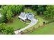 Stunning aerial view of a luxurious estate with a pool, manicured lawn, and a long driveway at 2101 Thomas Rd, Canton, GA 30115
