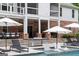 Backyard area with a pool, loungers, and covered patio, offering a relaxing outdoor space at 2101 Thomas Rd, Canton, GA 30115