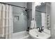 Modern bathroom features a bathtub with shower, gray tile, and a vanity with a vessel sink at 2101 Thomas Rd, Canton, GA 30115