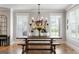 Elegant dining room featuring a wooden table, benches, and sophisticated chandelier lighting at 2101 Thomas Rd, Canton, GA 30115