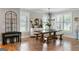 Formal dining room featuring a wooden table, benches, and sophisticated chandelier lighting at 2101 Thomas Rd, Canton, GA 30115