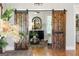 Welcoming foyer showcasing sliding barn doors, a decorative mirror, and stylish furnishings at 2101 Thomas Rd, Canton, GA 30115