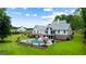 Beautiful exterior showcasing an in-ground pool and sprawling lawn with lovely greenery at 2101 Thomas Rd, Canton, GA 30115