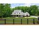 Charming modern farmhouse with a welcoming front porch, beautiful landscaping, and a black fence at 2101 Thomas Rd, Canton, GA 30115