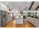 Open kitchen with stainless steel appliances, white cabinets, island, and hardwood floors at 2101 Thomas Rd, Canton, GA 30115