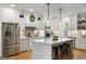 Modern kitchen with white cabinets, stainless steel appliances, and a center island with seating at 2101 Thomas Rd, Canton, GA 30115