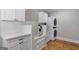 Well-organized laundry room with white cabinets, dog washing station, and modern washer/dryer unit at 2101 Thomas Rd, Canton, GA 30115