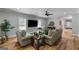 Cozy living room featuring neutral furniture, a ceiling fan, and ample natural light, perfect for relaxation at 2101 Thomas Rd, Canton, GA 30115