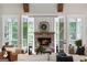 Cozy living room with fireplace, comfortable seating, and serene backyard views at 2101 Thomas Rd, Canton, GA 30115